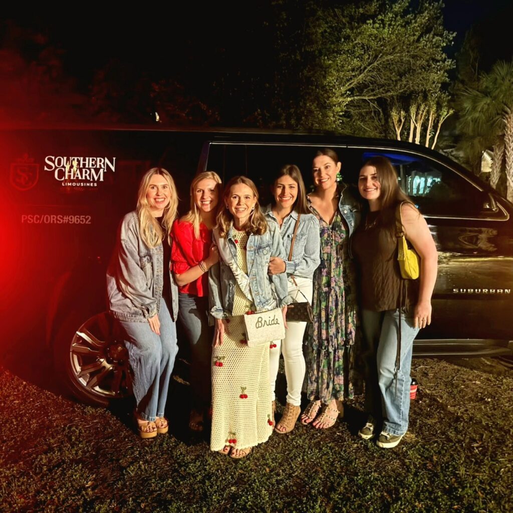 Bachelorette party limo Myrtle Beach: Bride and friends pose by Southern Charm Limousines SUV