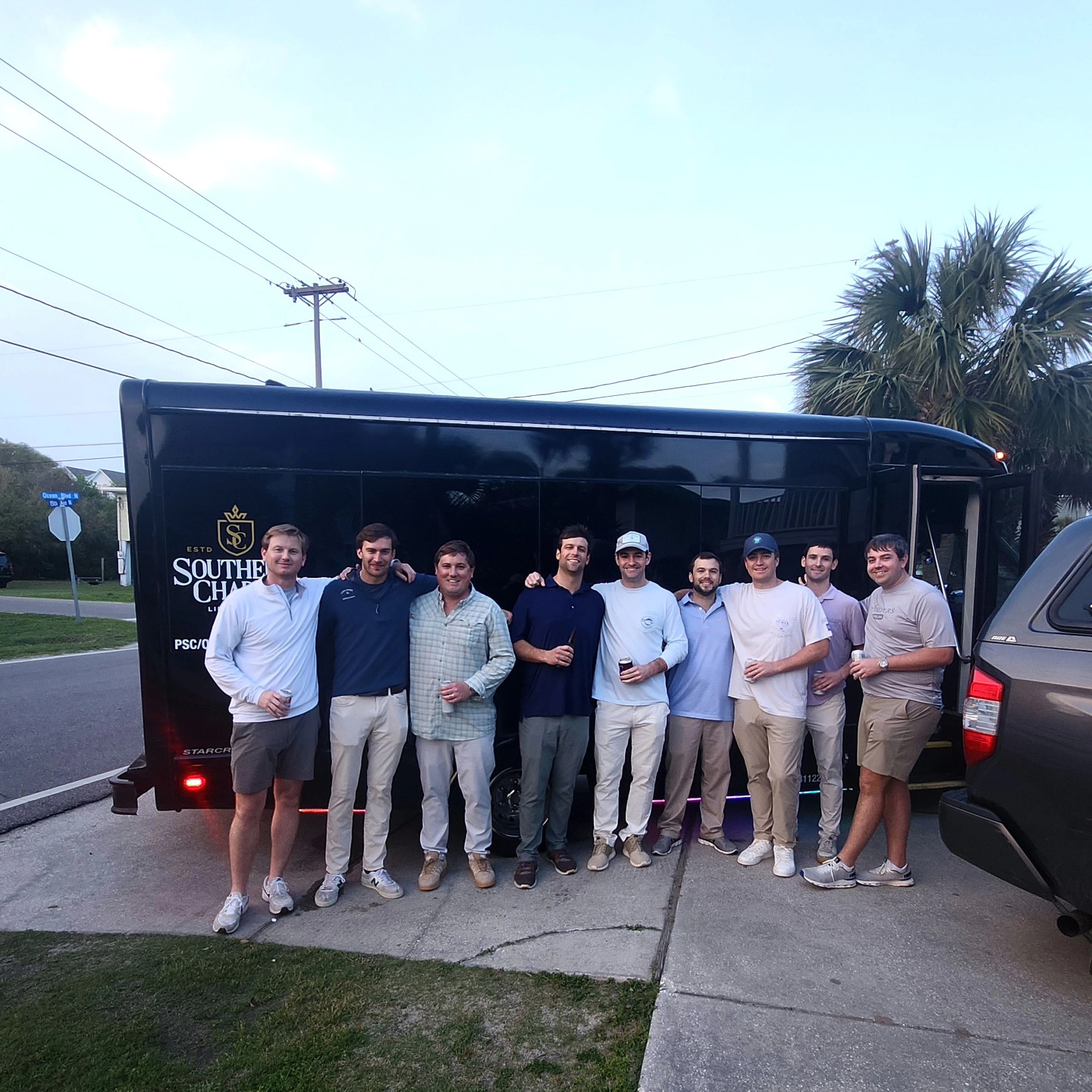 Group of young men by a black prom limo in Myrtle Beach