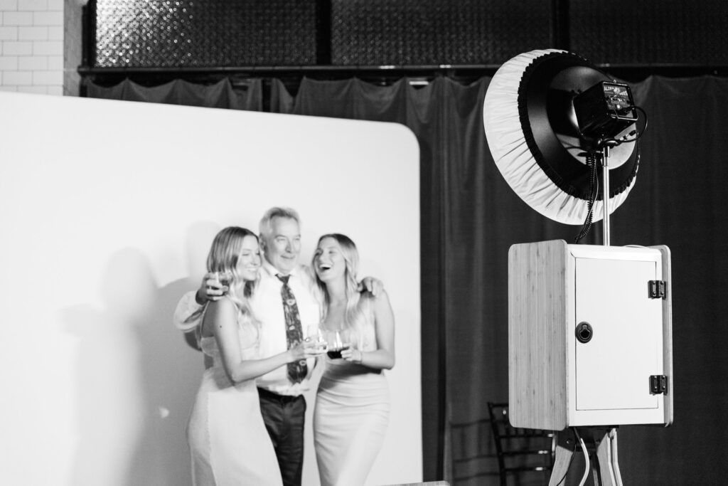 Man with two women in open air photo booth rental, Myrtle Beach.