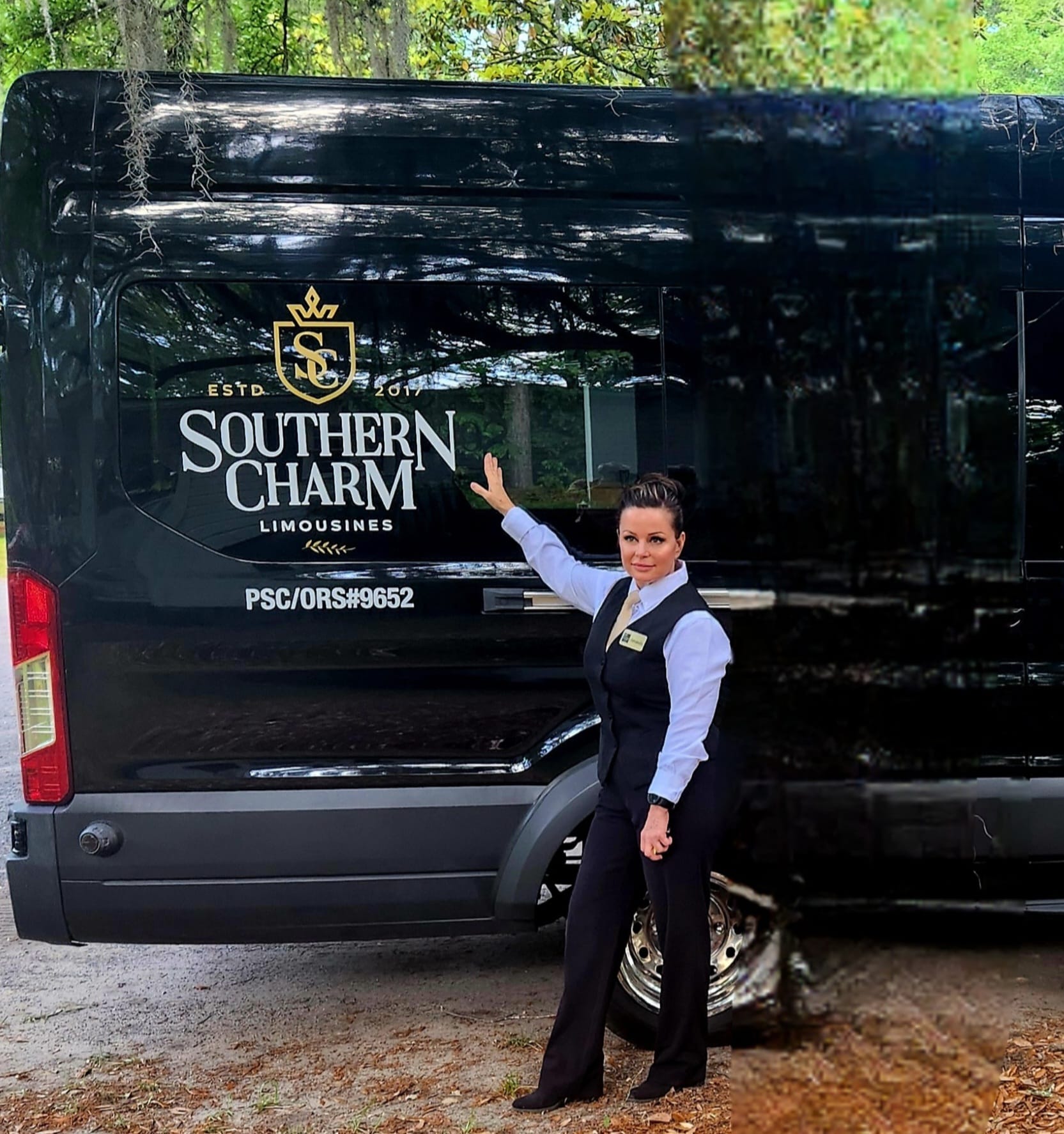 Southern Charm Limousines employee poses by a black limousine with company logo.