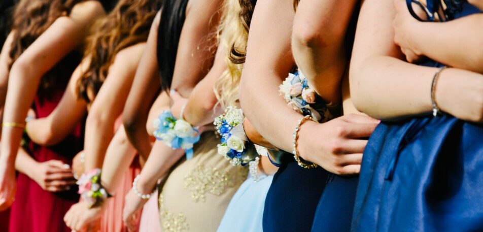 woman in blue sleeveless dress wearing blue and white floral tiara