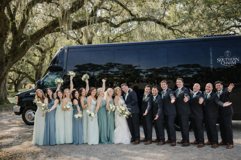 Wedding party poses by a Southern Charm limo in Pawleys Island.